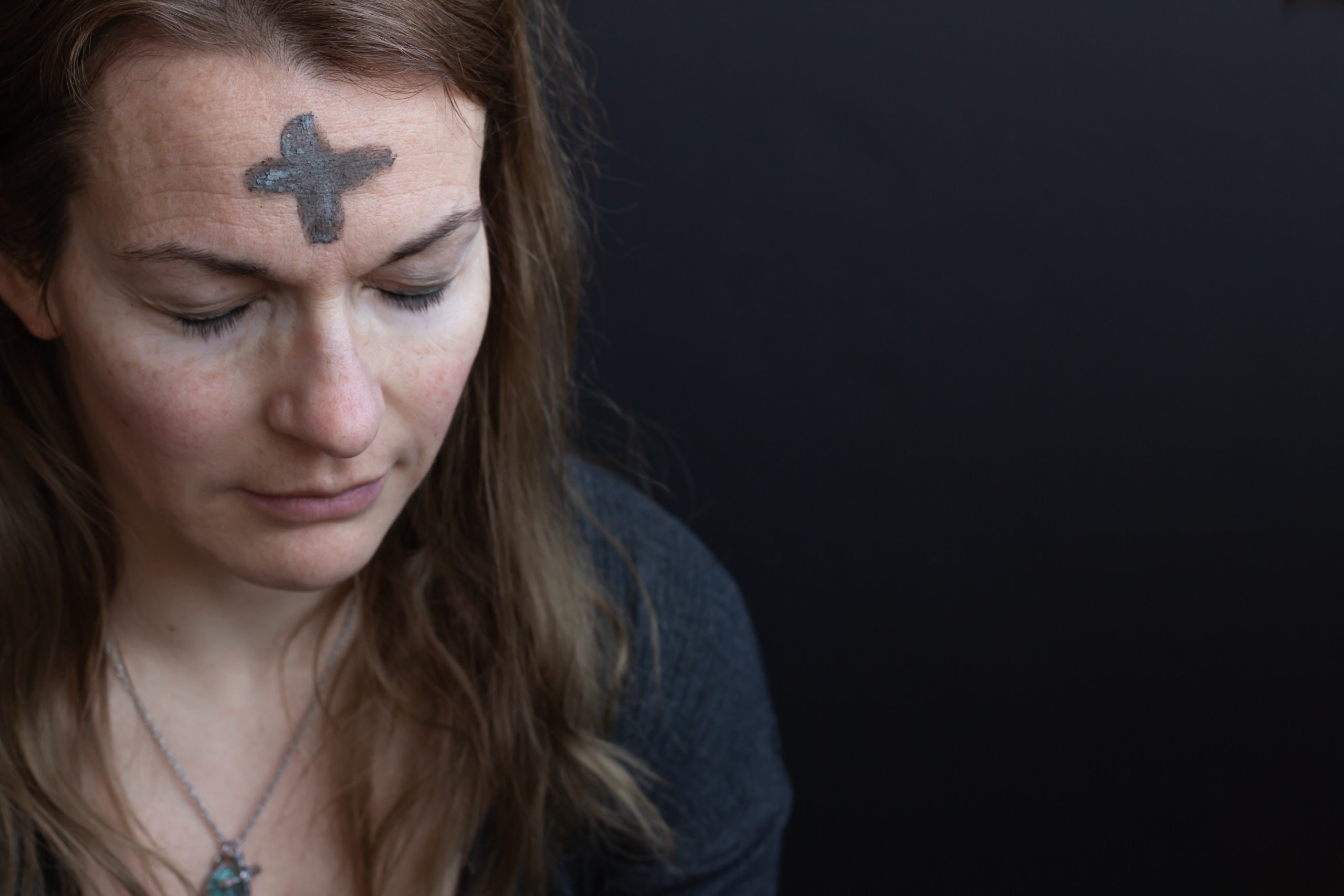 portrait of woman with ash cross on forehead